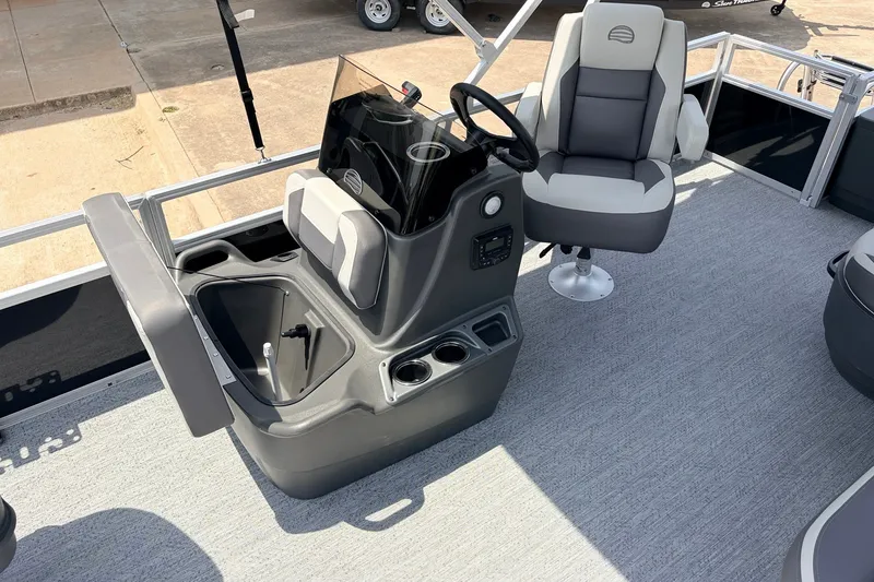 Slide: The Image of 2027 Sun Tracker Bass Buggy 18 DLX boat interior with captain's chair and console. - 20