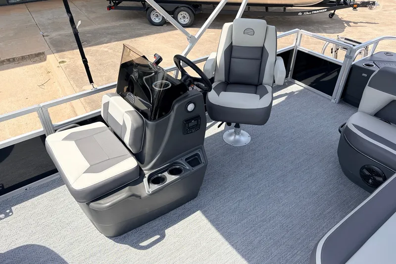 Slide: The Image of 2027 Sun Tracker Bass Buggy 18 DLX interior with helm and seating area. - 19