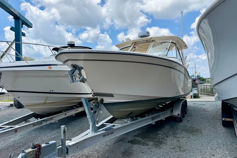 The Image of 2018 Grady-White Freedom 325 boat on trailer under a cloudy sky. - 0