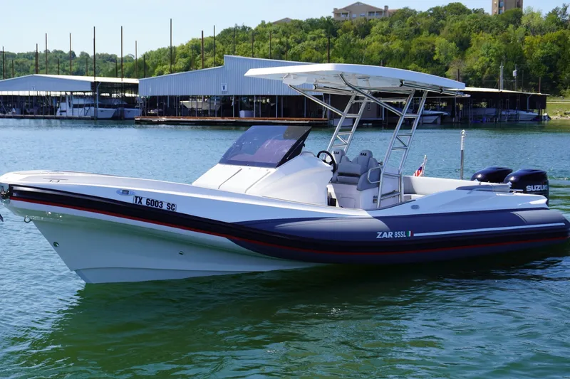The Image of 2025 Zar Formenti 85 SL boat on a lake, featuring sleek design and dual Suzuki engines. - 0
