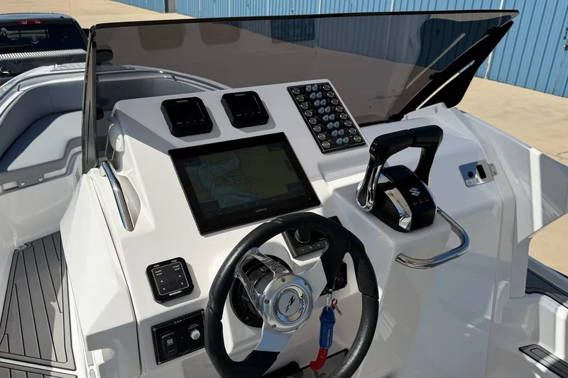 Slide: The Image of 2025 Zar Formenti 85 SL boat dashboard with steering wheel and navigation controls. - 19