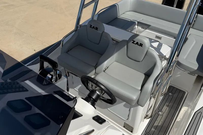 Slide: The Image of 2025 Zar Formenti 85 SL boat interior with sleek gray seating and modern controls. - 18