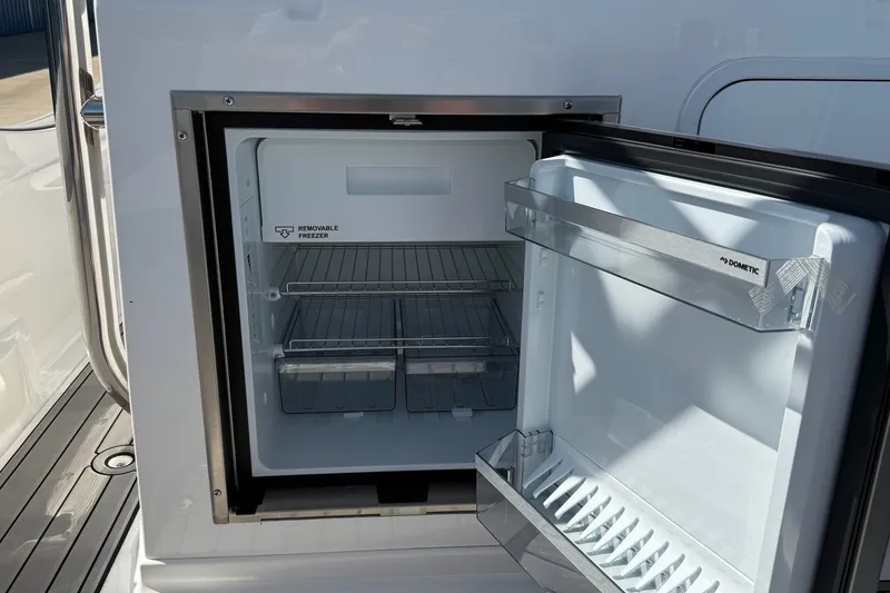 Slide: The Image of Open Dometic fridge on Zar Formenti 85 SL boat, showcasing removable freezer, 2025 model. - 14