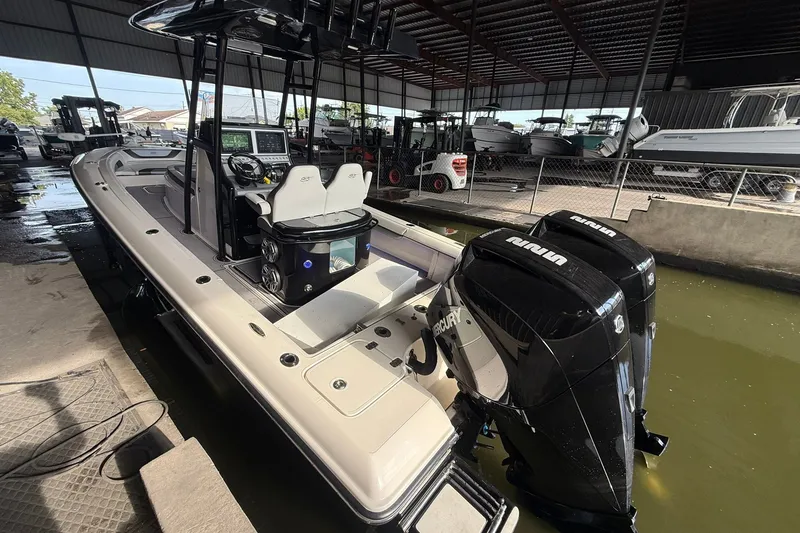 Slide: The Image of 2020 ShearWater 270 Carolina Flare boat with dual Mercury engines in a covered dock. - 30