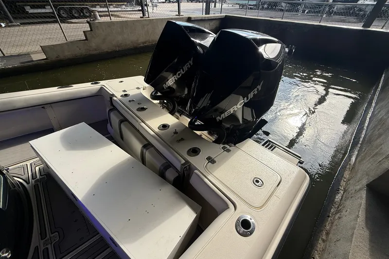 Slide: The Image of 2020 ShearWater 270 Carolina Flare boat with dual Mercury engines docked in water. - 29