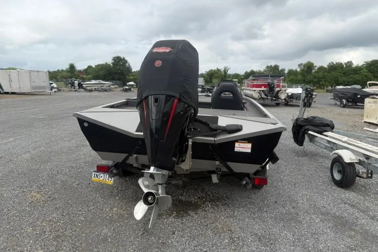 Slide: The Image of 2021 Crestliner MX 21 boat with covered outboard motor in a gravel lot. - 16