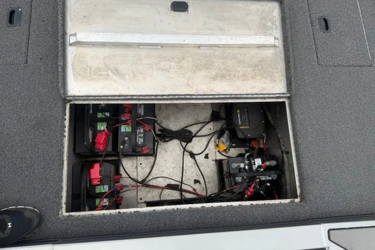 Slide: The Image of Battery compartment of a 2021 Crestliner MX 21 boat, showing wiring and connections. - 15
