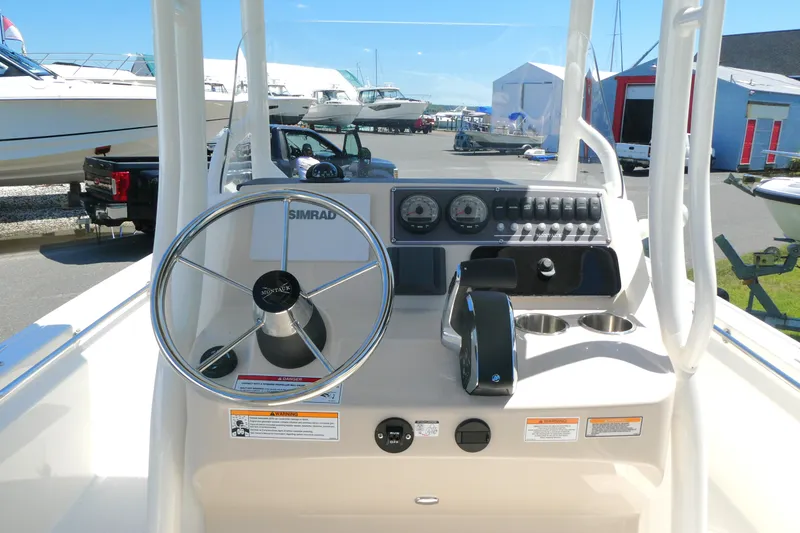 Slide: The Image of 2027 Boston Whaler 210 Montauk boat console with steering wheel and controls. - 8