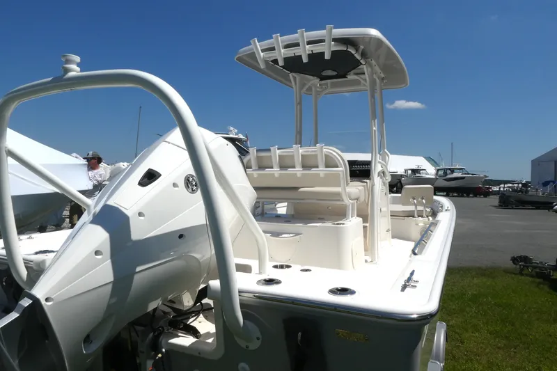 Slide: The Image of 2027 Boston Whaler 210 Montauk boat displayed outdoors under clear blue sky. - 3