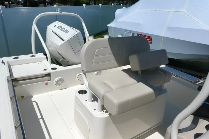Slide: The Image of 2027 Boston Whaler 210 Montauk boat interior with seating and motor. - 9