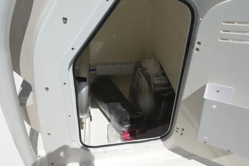 Slide: The Image of Storage compartment of 2027 Boston Whaler 210 Montauk boat, containing various items. - 12