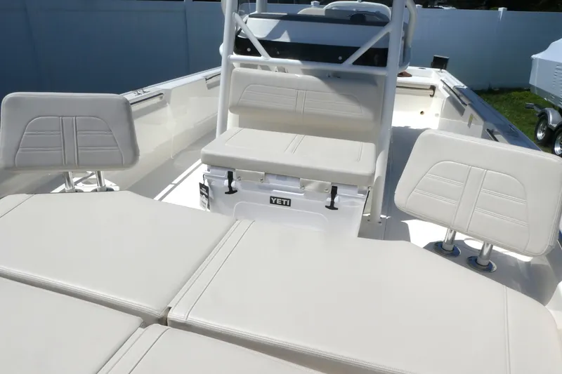 Slide: The Image of 2027 Boston Whaler 210 Montauk boat interior with white seating and Yeti cooler. - 11