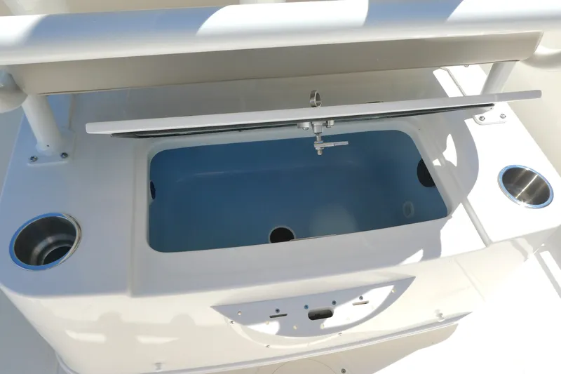 Slide: The Image of Livewell on 2027 Boston Whaler 210 Montauk boat, featuring cup holders and open lid. - 7
