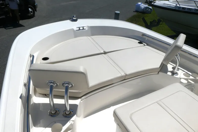 Slide: The Image of 2027 Boston Whaler 210 Montauk boat interior with cushioned seating and stainless steel fixtures. - 10