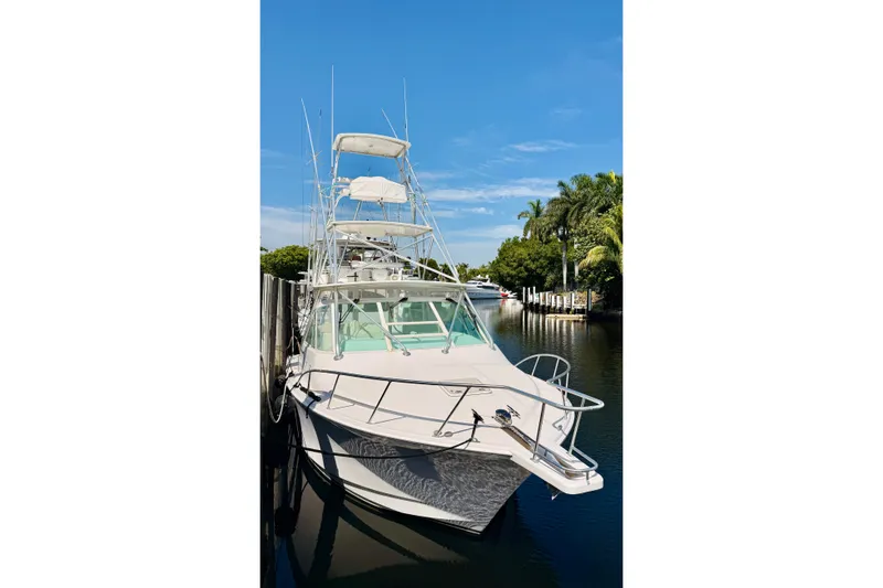 Slide: The Image of 2004 Cabo 35 Express boat docked on a sunny day with clear blue skies. - 2
