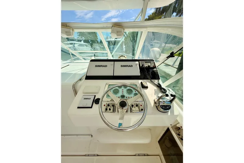 Slide: The Image of Helm of 2004 Cabo 35 Express boat with Simrad navigation equipment. - 14