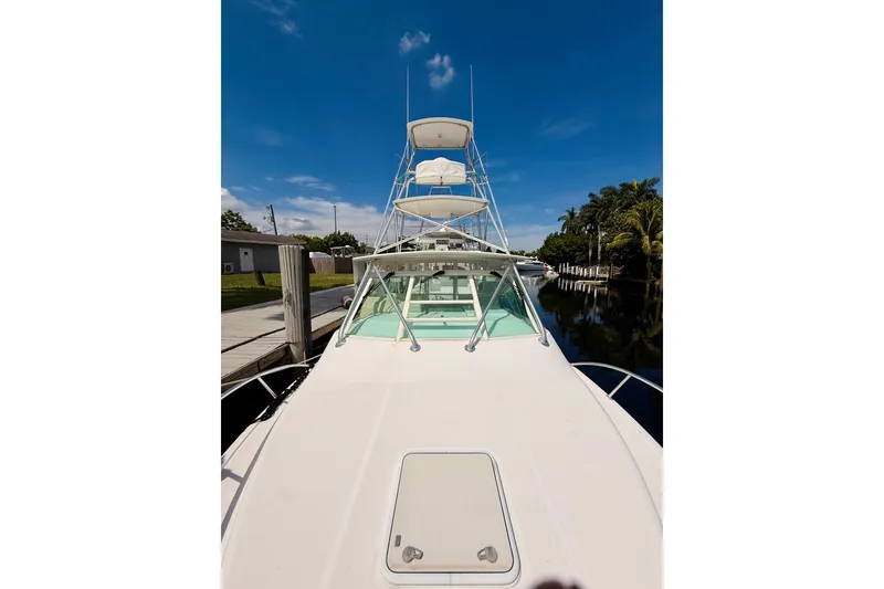 Slide: The Image of 2004 Cabo 35 Express boat docked under clear blue sky. - 41