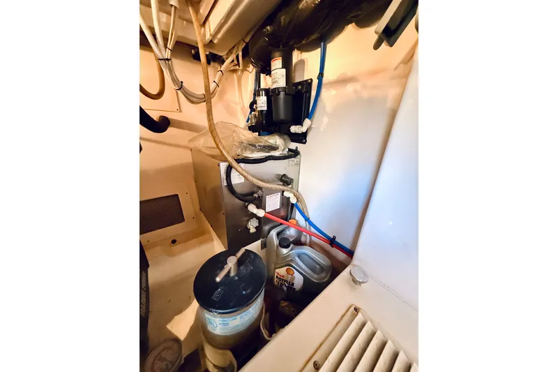 Slide: The Image of Engine room of 2004 Cabo 35 Express with mechanical components and oil container. - 32