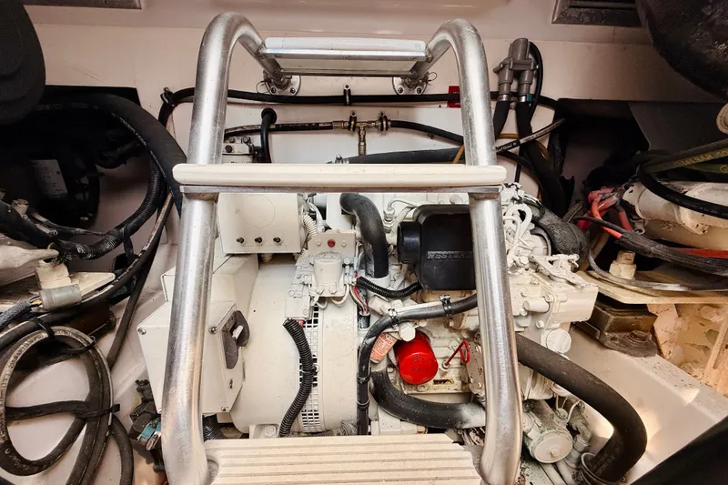 Slide: The Image of Engine compartment of a 2004 Cabo 35 Express boat, featuring mechanical components and wiring. - 30
