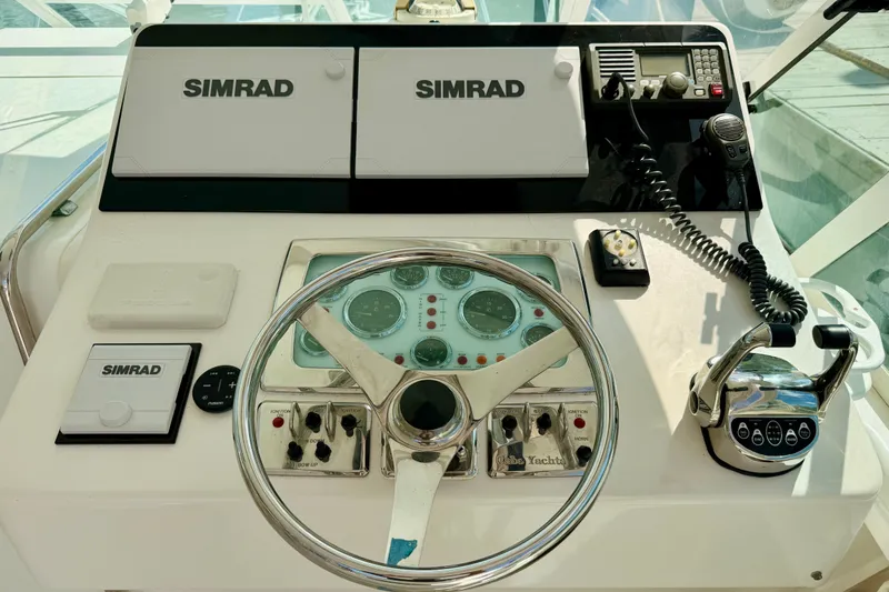 Slide: The Image of Control panel of a 2004 Cabo 35 Express boat with Simrad electronics. - 15