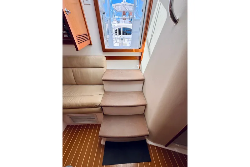 Slide: The Image of Interior of 2004 Cabo 35 Express yacht with stairs and seating area. - 28
