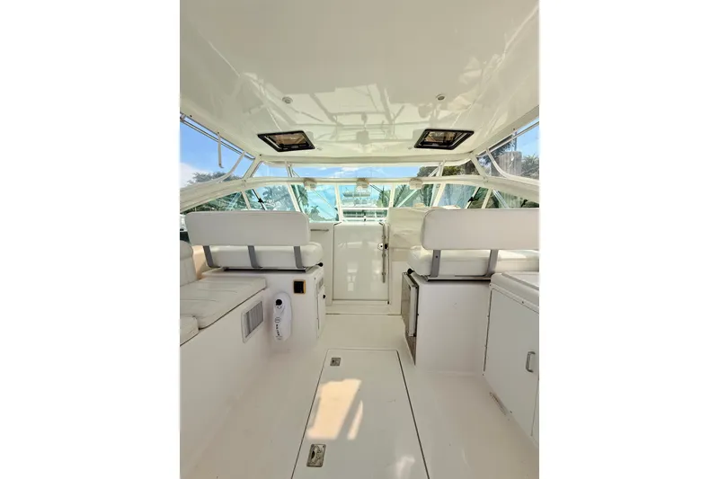 Slide: The Image of Interior of 2004 Cabo 35 Express boat with white seating and helm. - 10