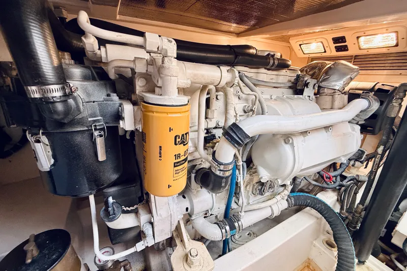 Slide: The Image of Engine room of a 2004 Cabo 35 Express boat, featuring a CAT fuel filter. - 33