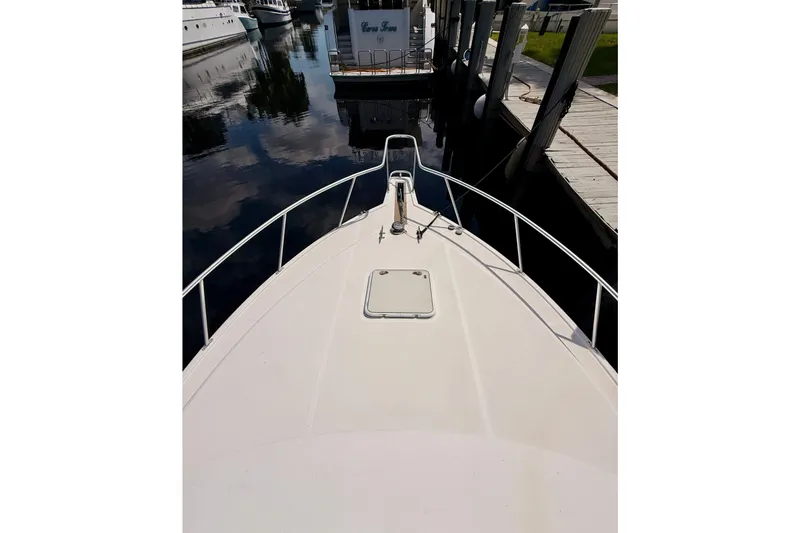 Slide: The Image of Bow view of 2004 Cabo 35 Express yacht docked at marina. - 38
