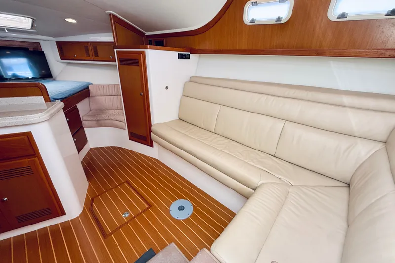 Slide: The Image of Luxurious interior of 2004 Cabo 35 Express yacht with leather seating and wooden accents. - 17