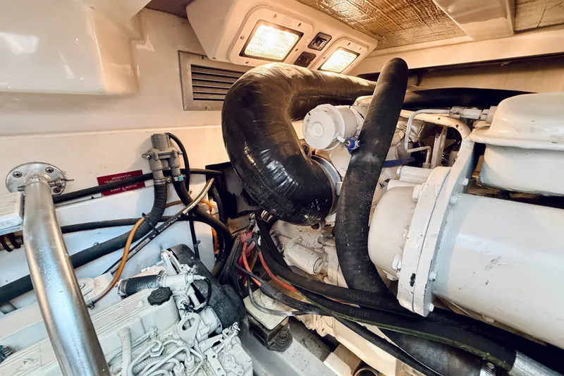 Slide: The Image of Engine room of a 2004 Cabo 35 Express boat, showcasing mechanical components and wiring. - 37