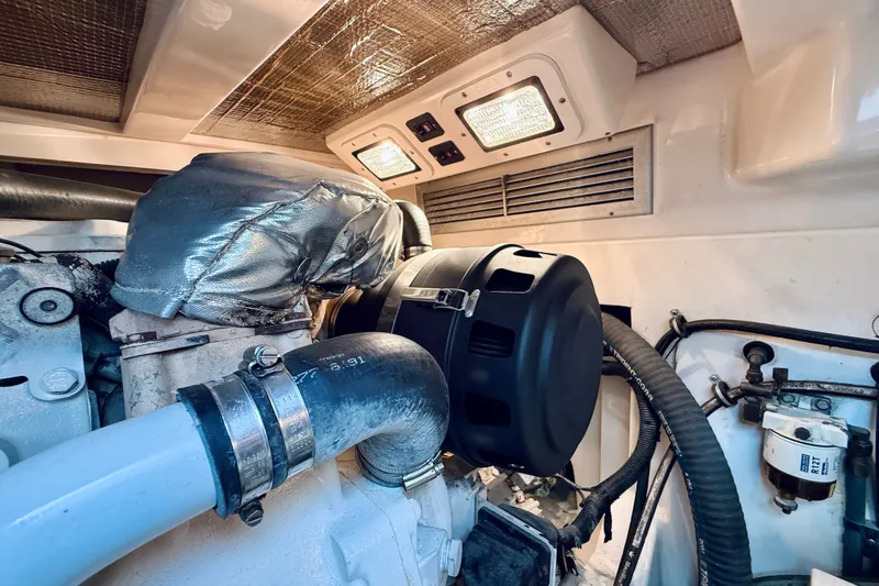 Slide: The Image of Engine room of 2004 Cabo 35 Express boat, showcasing mechanical components and ventilation. - 36