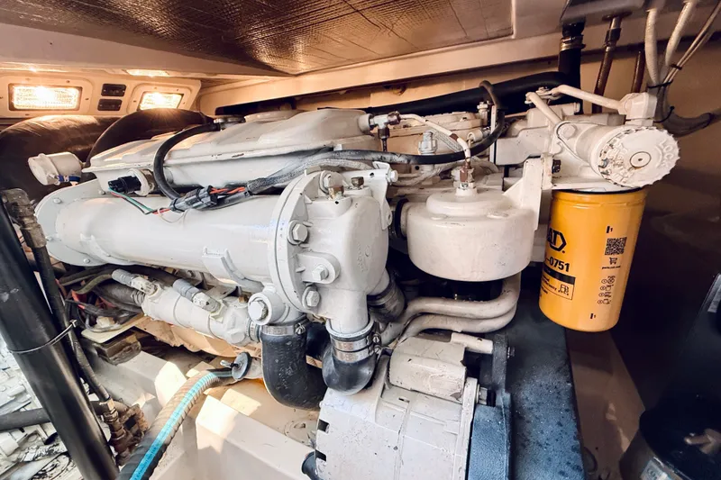 Slide: The Image of Engine compartment of a 2004 Cabo 35 Express boat, showcasing detailed machinery. - 34