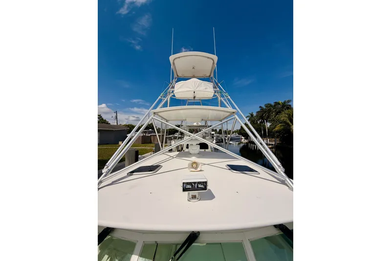 Slide: The Image of 2004 Cabo 35 Express boat with tower against a clear blue sky. - 42