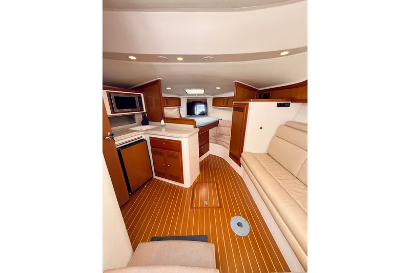 Slide: The Image of Interior of 2004 Cabo 35 Express yacht with wood flooring and modern amenities. - 16