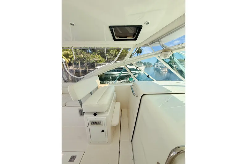 Slide: The Image of Interior view of 2004 Cabo 35 Express boat with white seating and clear windows. - 12