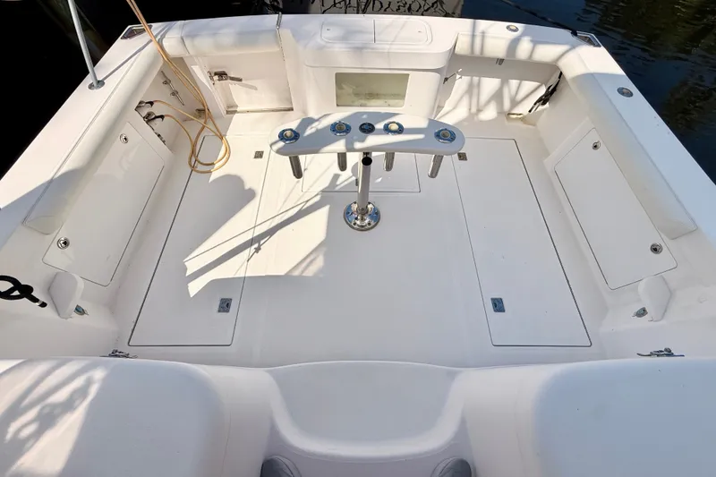 Slide: The Image of 2004 Cabo 35 Express boat deck with fishing rod holders and storage compartments. - 9