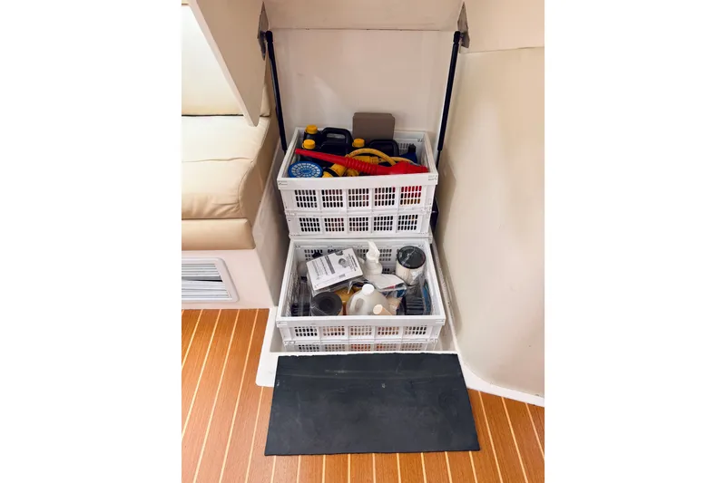 Slide: The Image of Storage compartment with organized baskets on a 2004 Cabo 35 Express boat. - 29