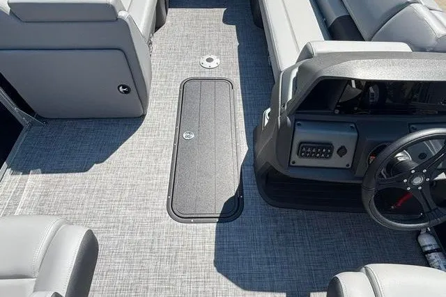 Slide: The Image of Interior of 2026 Sun Tracker Party Barge 22 XP3 with gray seating and steering console. - 13