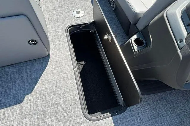 Slide: The Image of 2026 Sun Tracker Party Barge 22 XP3 storage compartment with open hatch and seating area. - 14