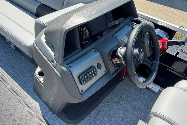 Slide: The Image of 2026 Sun Tracker Party Barge 22 XP3 dashboard with steering wheel and controls. - 16