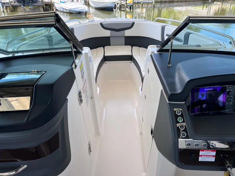 Slide: The Image of 2022 Chaparral 267 SSX OB boat interior with modern dashboard and seating. - 27