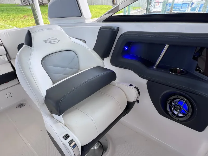 Slide: The Image of 2022 Chaparral 267 SSX OB boat interior with luxury seating and blue LED lighting. - 22