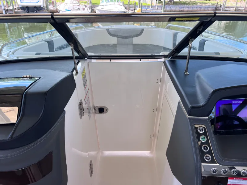 Slide: The Image of 2022 Chaparral 267 SSX OB boat interior with open windshield and control panel. - 28