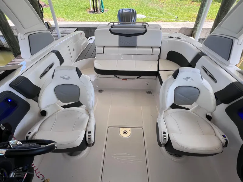 Slide: The Image of 2022 Chaparral 267 SSX OB boat interior with white seating and modern design. - 38