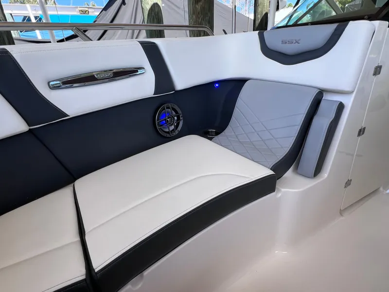 Slide: The Image of 2022 Chaparral 267 SSX OB boat interior with stylish seating and speaker. - 32