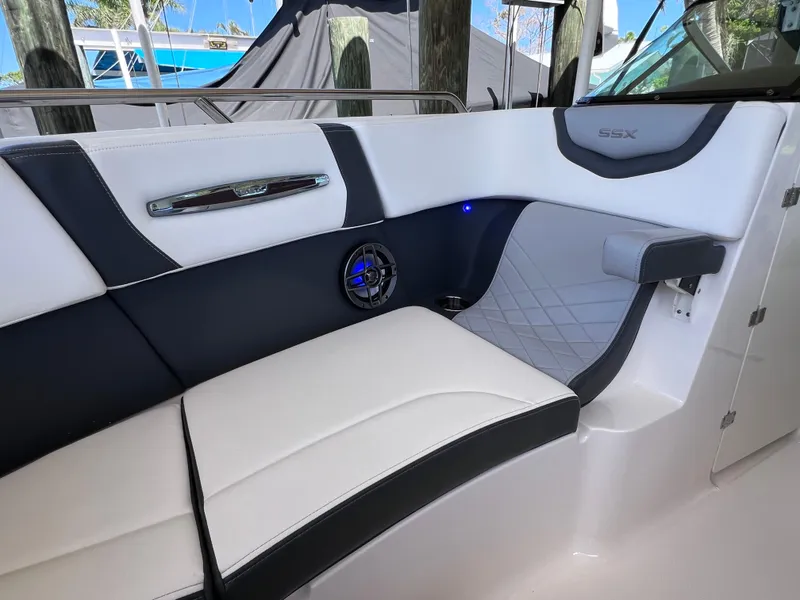 Slide: The Image of 2022 Chaparral 267 SSX OB boat interior with stylish seating and speaker. - 33