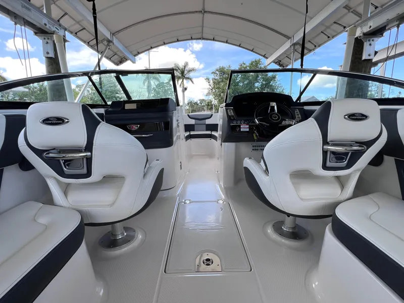Slide: The Image of Interior of 2022 Chaparral 267 SSX OB boat with white seating and modern dashboard. - 20
