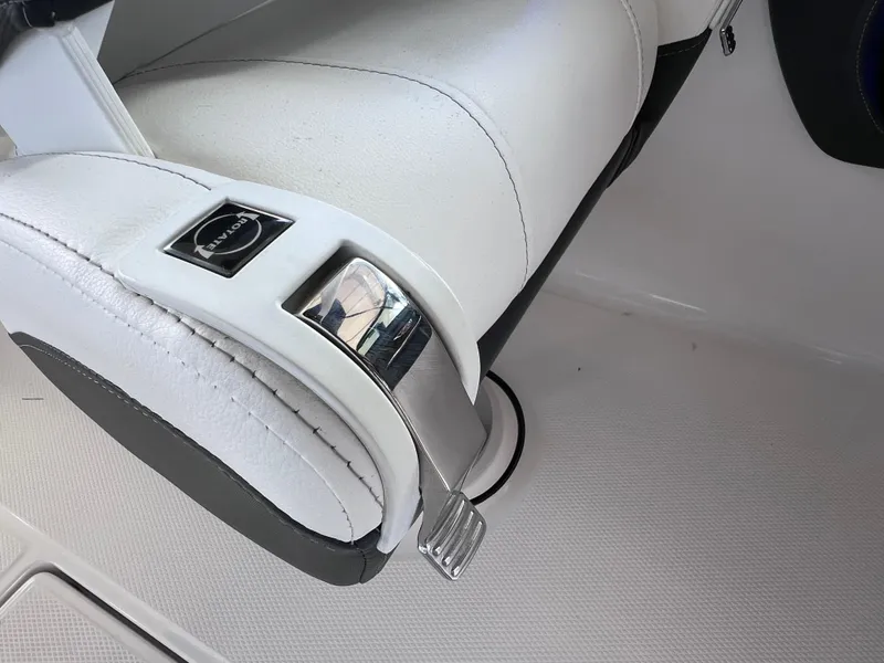 Slide: The Image of White leather seat detail in 2022 Chaparral 267 SSX OB boat interior. - 23