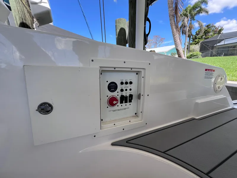 Slide: The Image of The image shows the control panel of a 2022 Chaparral 267 SSX OB with various switches. - 50