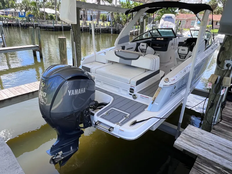 The Image of 2022 Chaparral 267 SSX OB boat with Yamaha outboard motor docked by waterfront. - 0